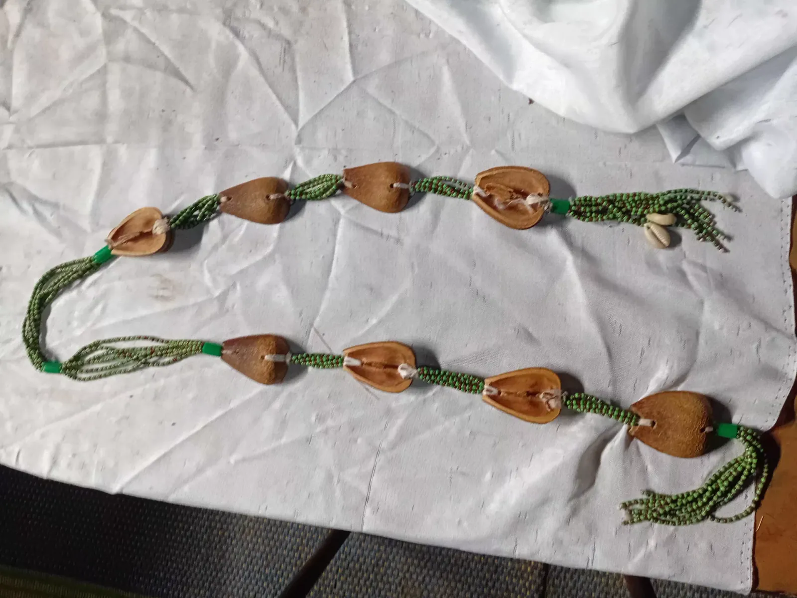 An opele, the Ifá divining chain of eight half seed pods.